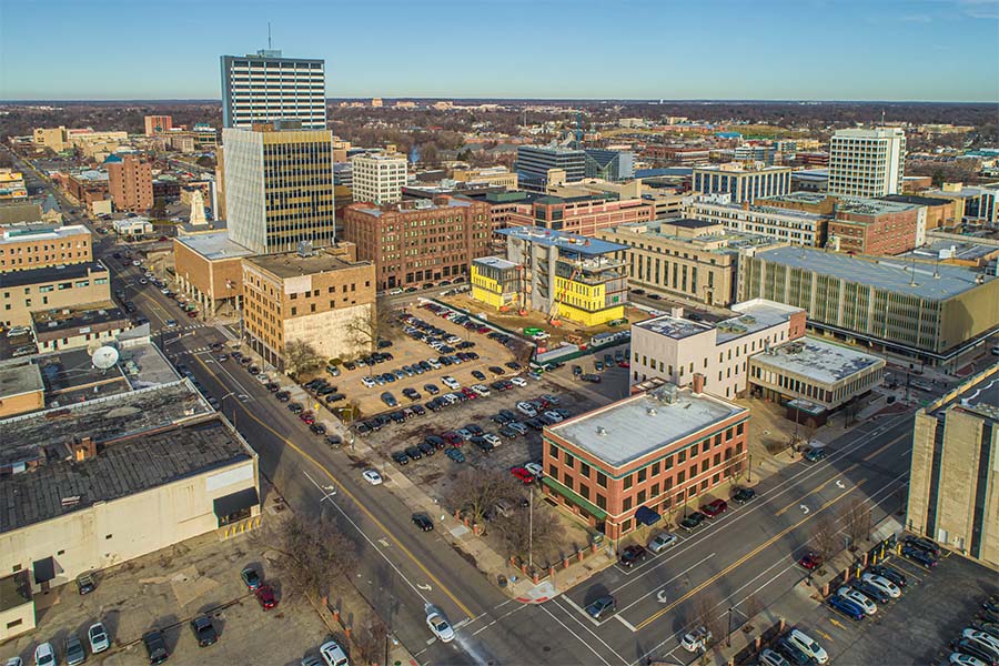 South Bend IN - Aerial View of Downtown South Bend Indiana with Views of Commercial Buildings and City Streets Against a Blue Sky